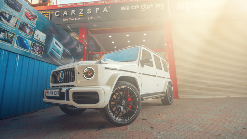 A white Mercedes G Wagon stands parked outside a CarzSpa Detailing Studio.
